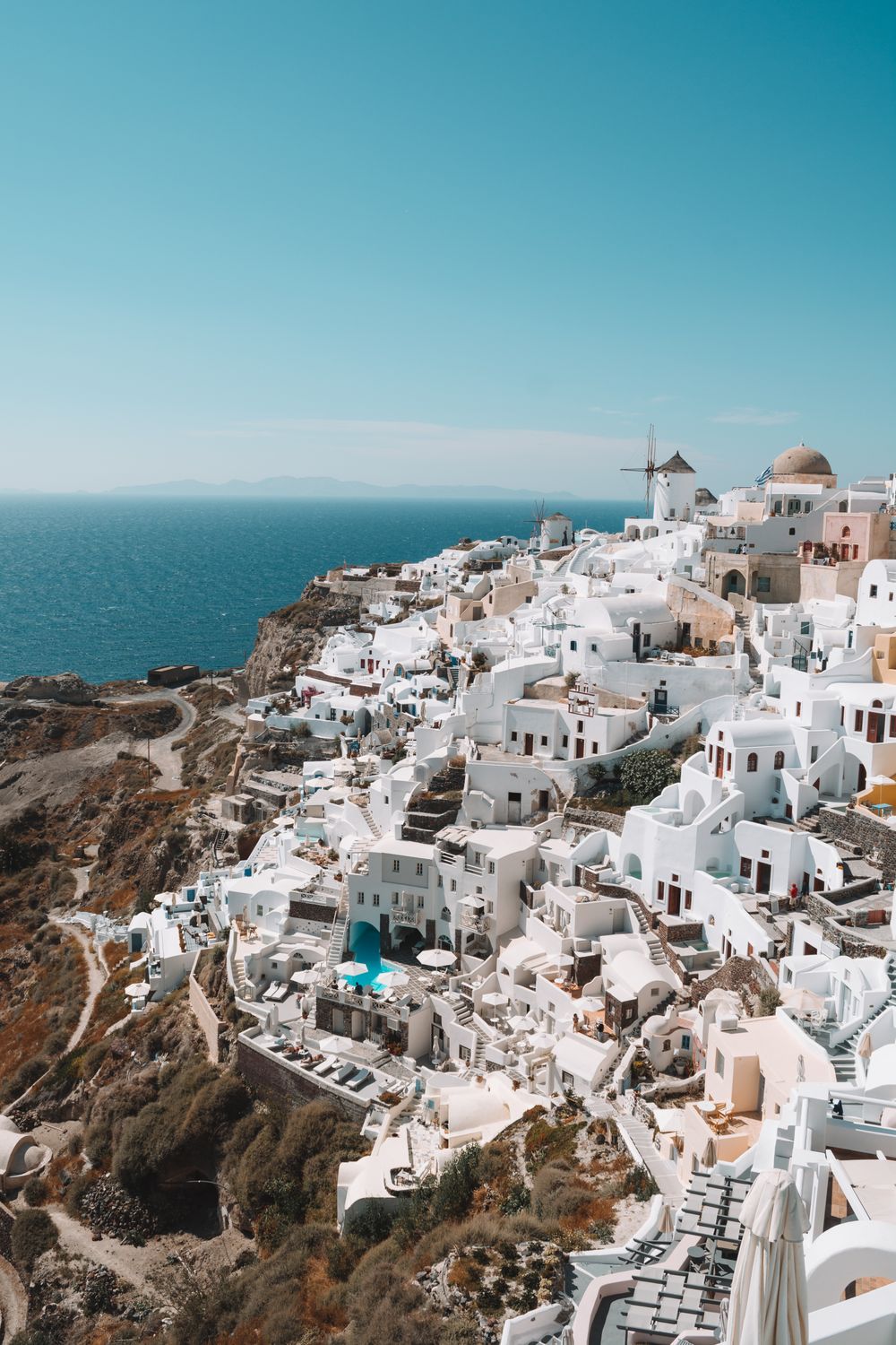 Whitewashed cliffside houses above the blue Aegean Sea in Santorini, Greece